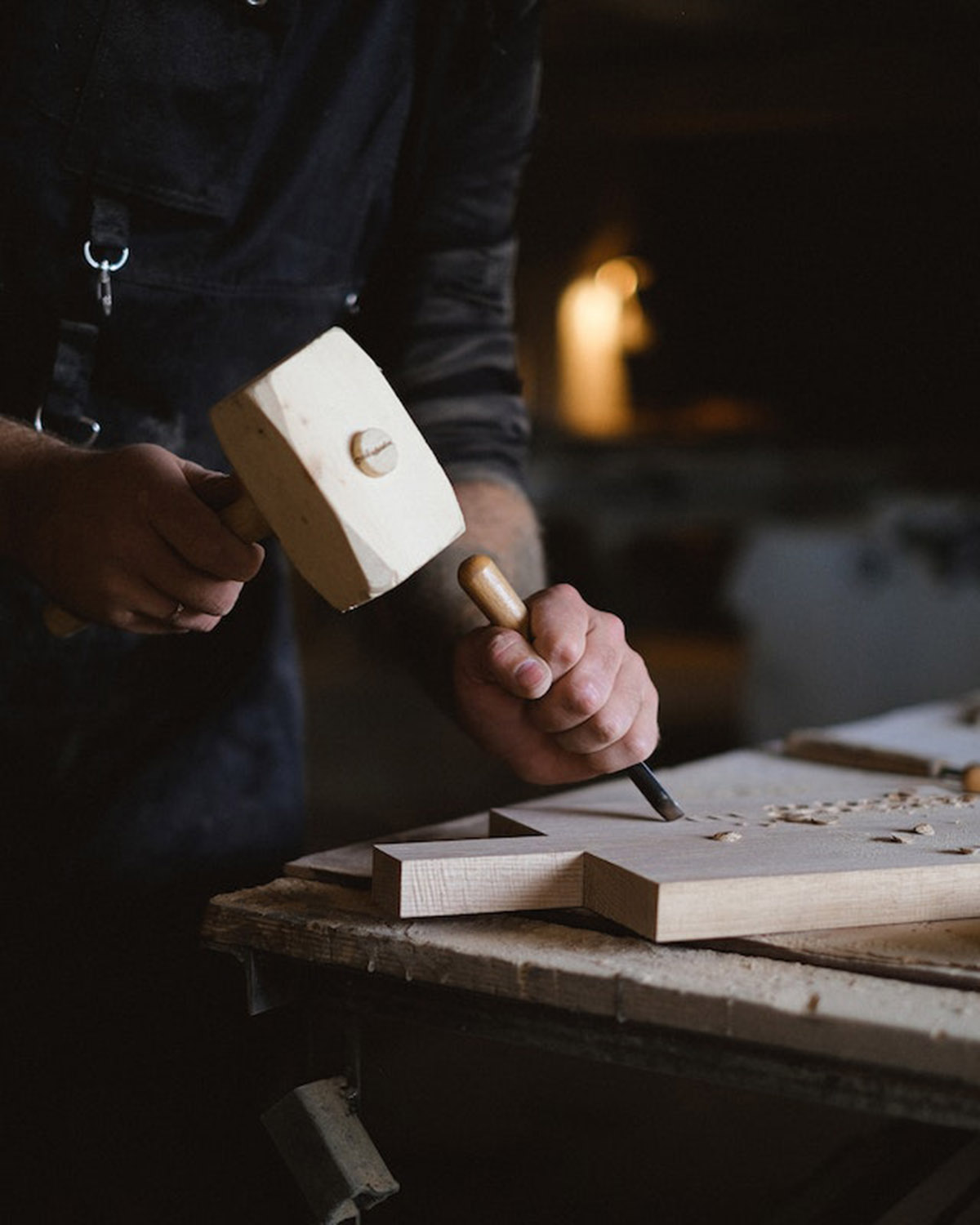 A man using a hammer and chisel