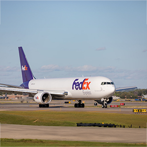 nick-morales-a_iqo9THK1o-unsplash A fedex airplane taxiing on the runway.
