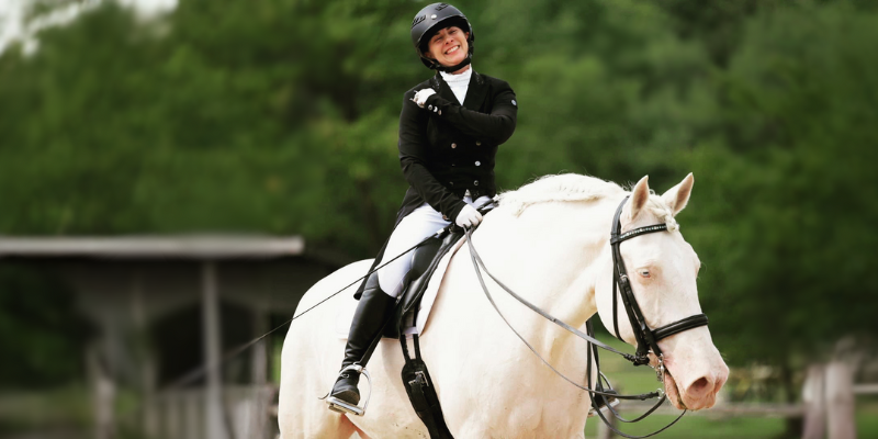 Dana Johnson on a white horse in equestrian attire
